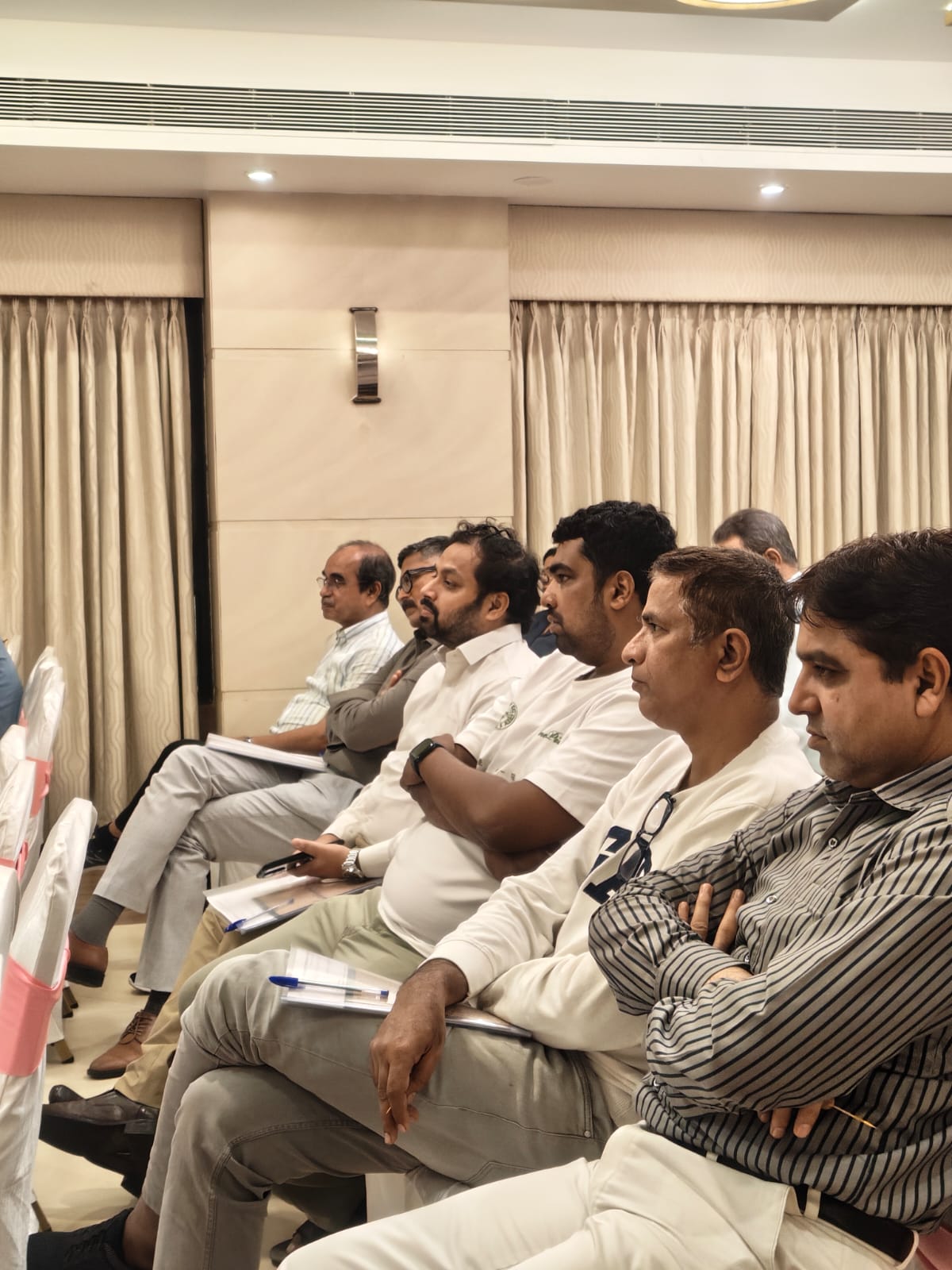 Members seated in the hall listening to the Annual General Body Meeting proceedings