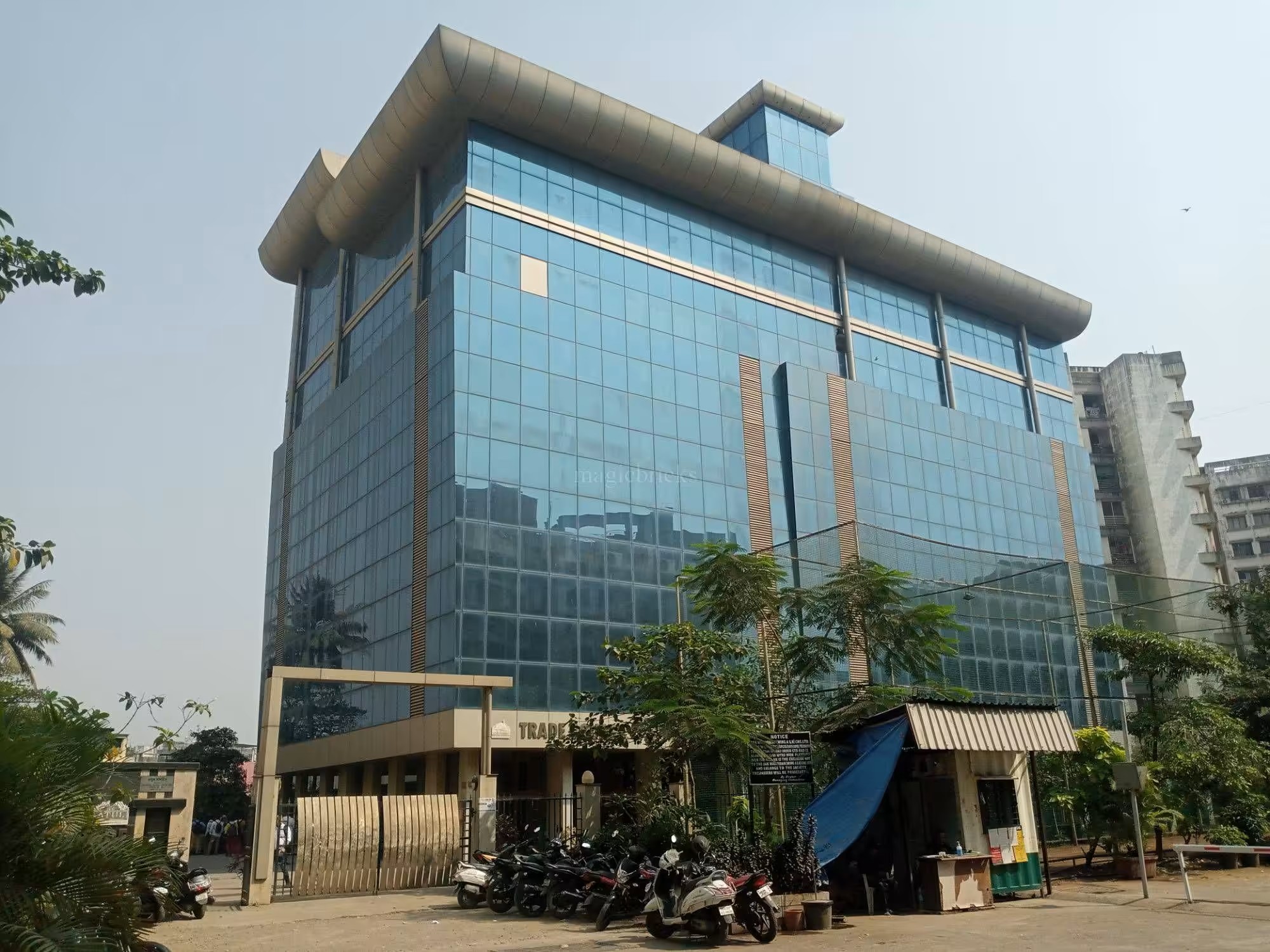 Exterior of Trade Square, the glass-facade commercial building at Saki Naka, Mumbai, with its TRADE SQUARE entrance signage